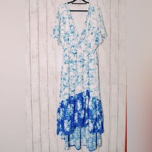 Beautiful blue & white faux wrap dress with flutter sleeve and a high-low hem.